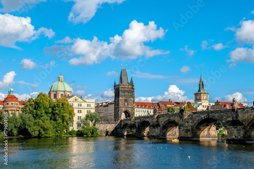 Beautiful view from the river Vltava on the Bank of Prague on a Sunny day with a dramatic sky.