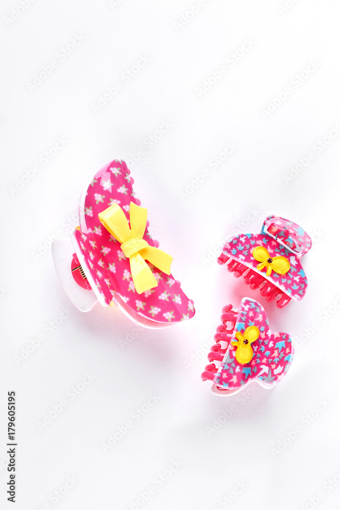 Brightful hair clips, top view. Kids fashionable plastic hair clips isolated on white background. Girls hair accessory.