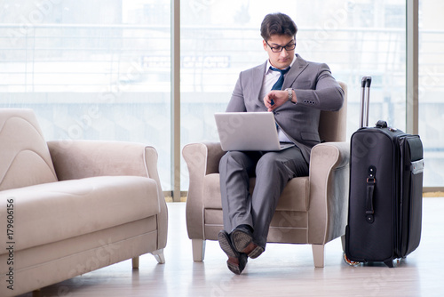 Young businessman in airport business lounge waiting for flight