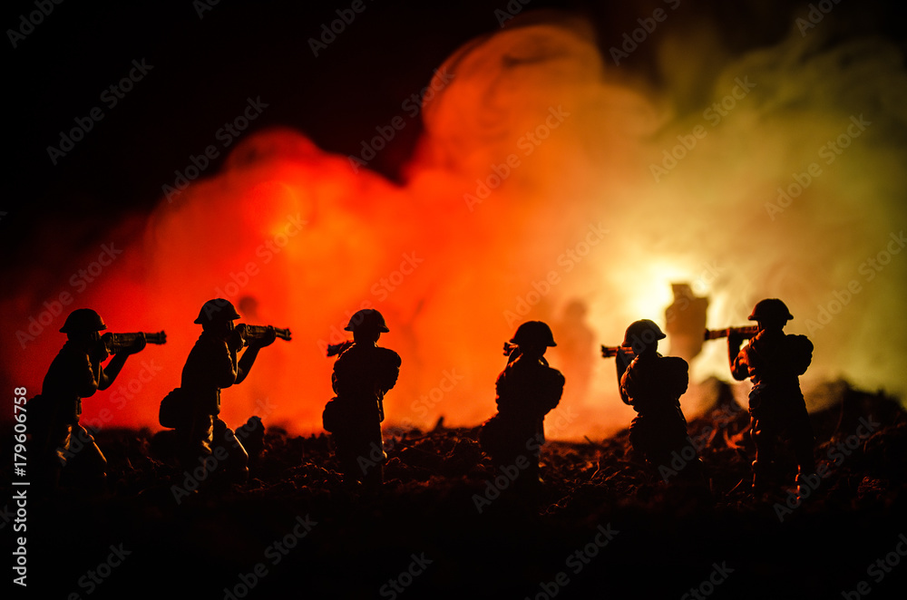 War Concept. Military silhouettes fighting scene on war fog sky background, World War Soldiers Silhouettes Below Cloudy Skyline At night. Attack scene. Armored vehicles. Selective focus