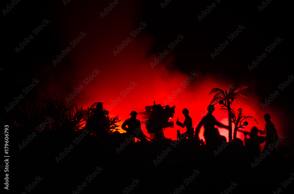 Fototapeta premium An anti-aircraft cannon and Military silhouettes fighting scene on war fog sky background, World War Soldiers Silhouettes Below Cloudy Skyline at sunset. Attack scene.