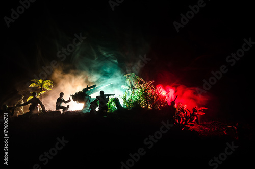 An anti-aircraft cannon and Military silhouettes fighting scene on war fog sky background  World War Soldiers Silhouettes Below Cloudy Skyline at sunset. Attack scene.