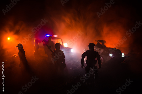 Anti-riot police give signal to be ready. Government power concept. Police in action. Smoke on a dark background with lights. Blue red flashing sirens. © zef art