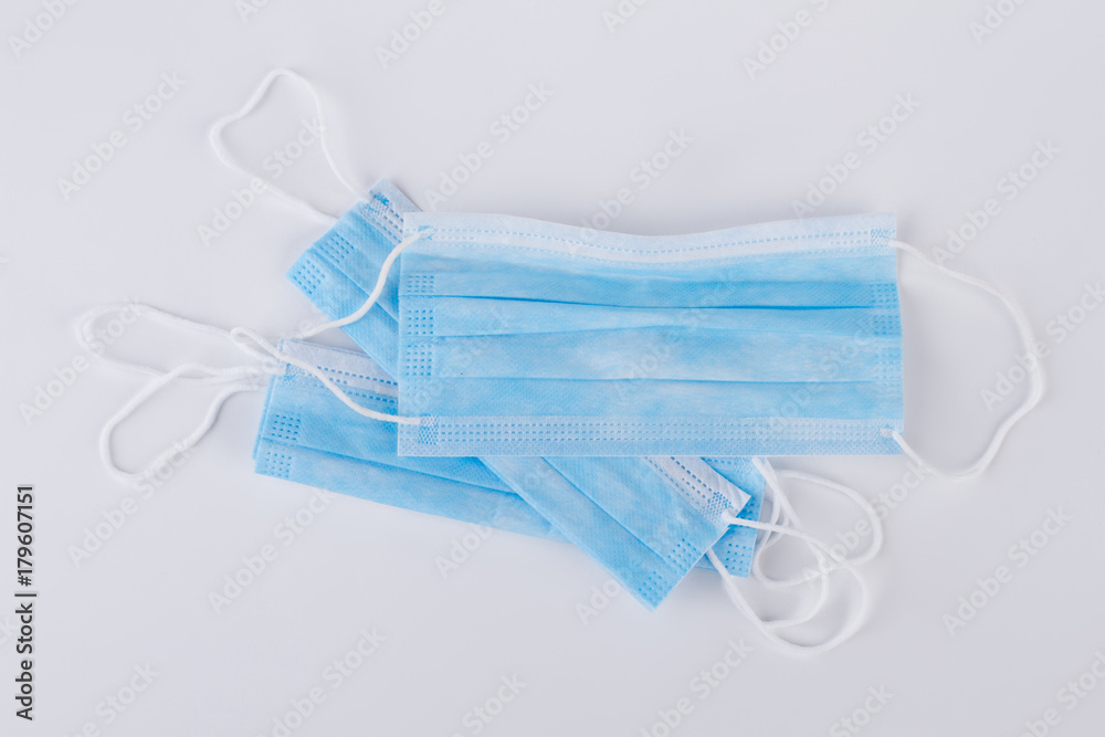 Disposable face mask over grey background. Medical surgical protective face masks with clipping path isolated on grey ackground. Disposable face mask over grey background. Medical surgical protective face masks with clipping path isolated on grey ackground.