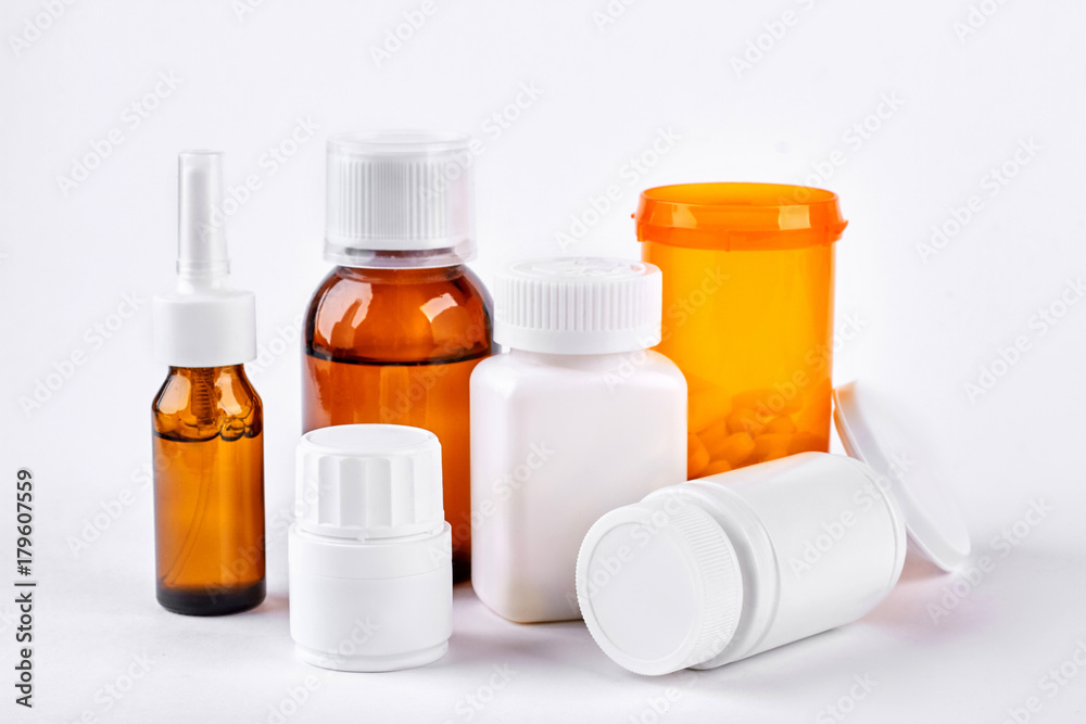 Traditional medicine to treat flu. Drugs and medical liquid in bottles for cold trreatment. Medicine, health care and pharmaceutical drugs concept. Traditional medicine to treat flu. Drugs and medical liquid in bottles for cold trreatment. Medicine, health care and pharmaceutical drugs concept.