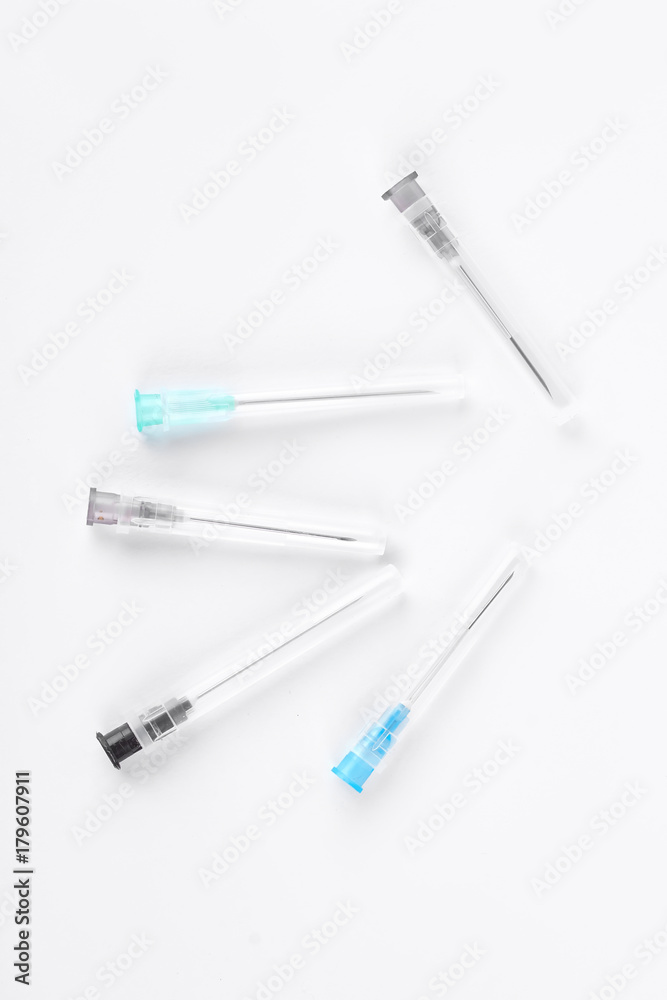 Set of medical syringe needles. Group of disposable hypodermic needles on white background, top view. Set of medical syringe needles. Group of disposable hypodermic needles on white background, top view.
