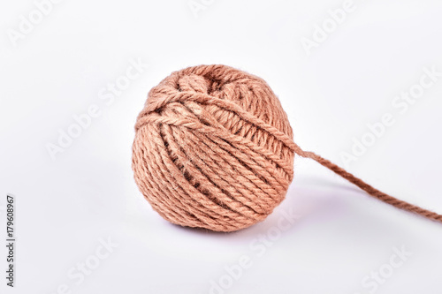Ball of brown yarn, white background. Ball of yarn for knitting, isolated on white background.