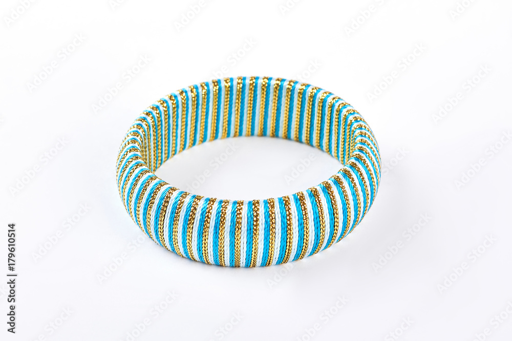Fashion striped bracelet on white background. Luxury blue bracelet isolated on white background. Female modern accessory. Fashion striped bracelet on white background. Luxury blue bracelet isolated on white background. Female modern accessory.