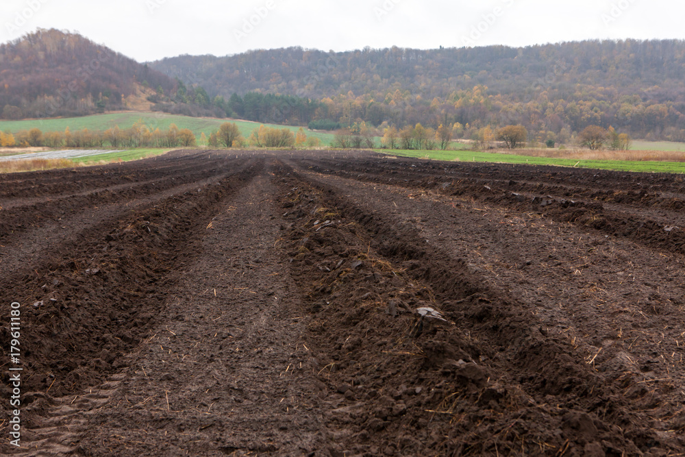 ploughed agriculture field with dark soil ploughed agriculture field with dark soil