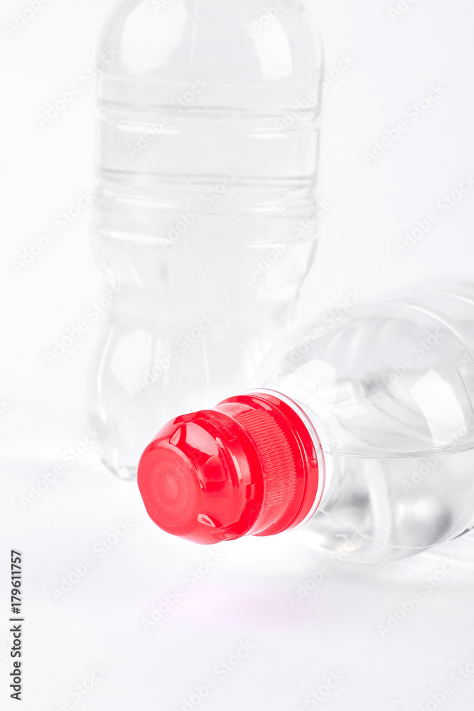 Natural purified water in plastic bottle. Transparent plastic bottles of water isolated on white background. Healthy lifestyle concept.