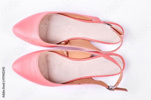 Female pink sandals, white background. Light pink low-heeled shoes isolated on a white background, top view Woman fashion outfit.