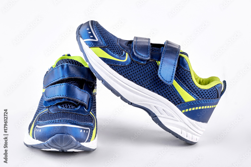 Blue and green sport trainers. New running sneakers isolated on white background. High quality footwear for sport training on sale. Blue and green sport trainers. New running sneakers isolated on white background. High quality footwear for sport training on sale.