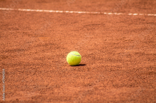 Tennis Ball on the ground court © kvdkz