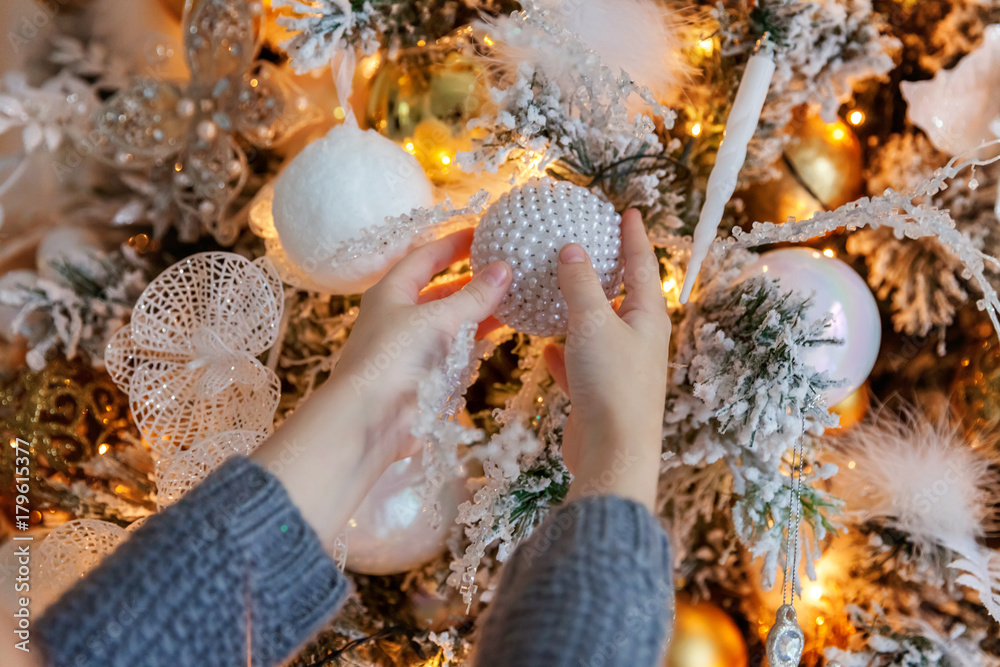 Young girl decorating Christmas tree Young girl decorating Christmas tree