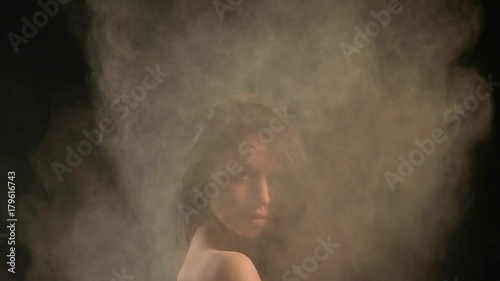 sexy model in studio posing with paints holi