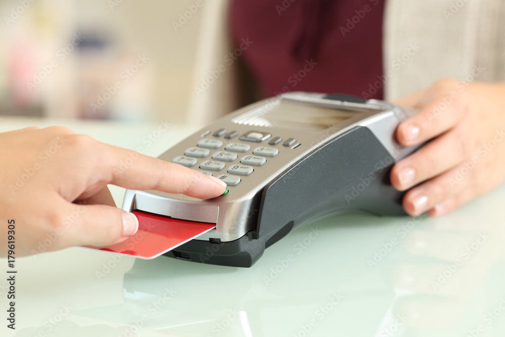 Customer typing pin in a credit card reader Customer typing pin in a credit card reader