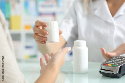 Pharmacist selling medicines to a customer photo