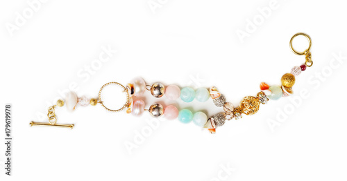 gold jewerly braslete with semiprecious at white background