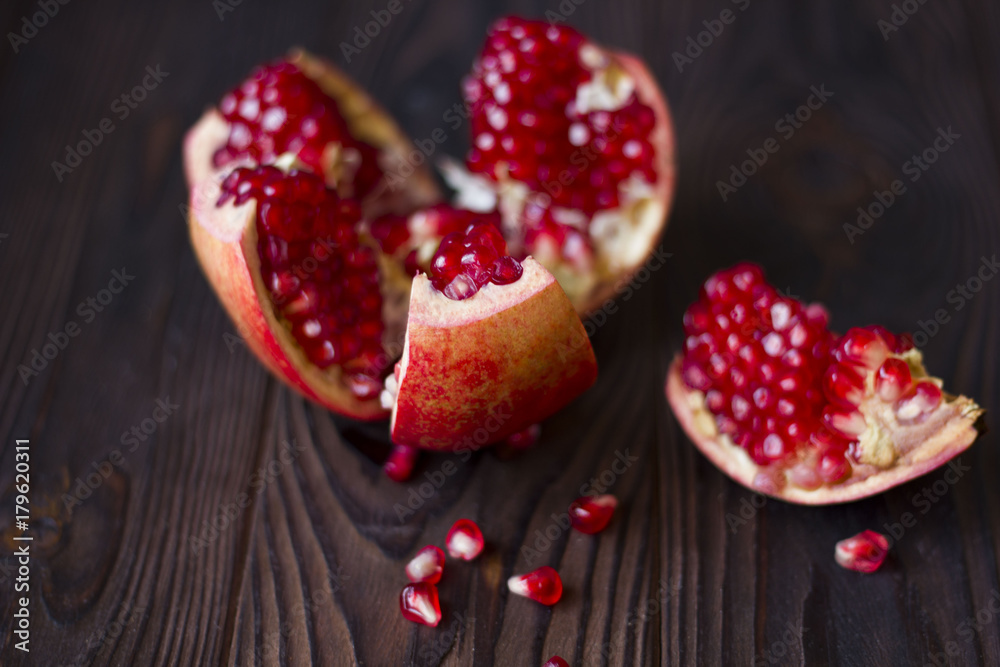 ruby pomegranate seeds in a clay bowl on wooden table ruby pomegranate seeds in a clay bowl on wooden table