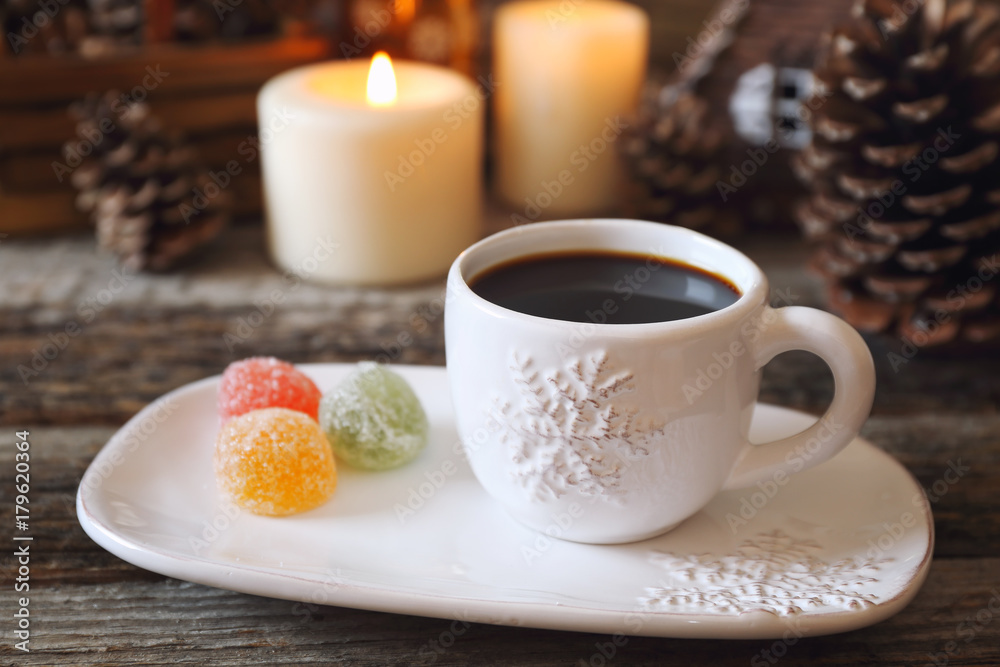 Fototapeta premium Christmas drink: coffee, colorful candy and burning candles