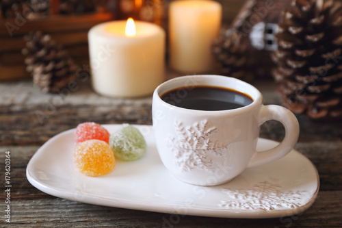 Christmas drink: coffee, colorful candy and burning candles