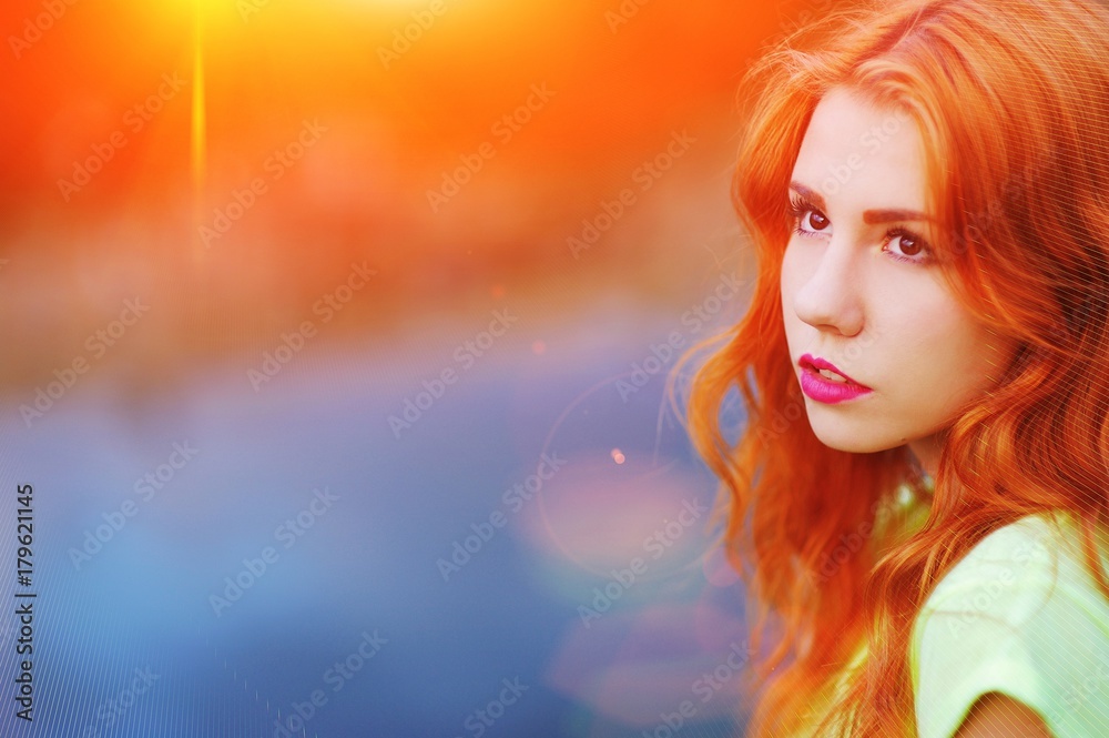Portrait of a very beautiful brown eyed girls with bright red hair in a light green dress on a background of lake, close-up Portrait of a very beautiful brown eyed girls with bright red hair in a light green dress on a background of lake, close-up