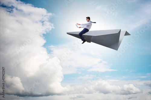 Businessman flying on paper plane in business concept © Elnur