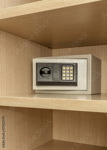 Safe box for storing valuables in a wooden cupboard.