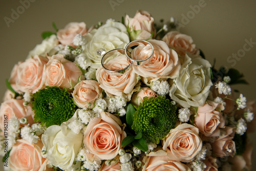 Wedding rings of bride and groom on wedding bouquet