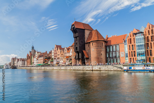 GDANSK, POLAND - SEPTEMBER 2, 2016: Riverside houses by Motlawa river in Gdansk, Poland. Medieval crane in the background.