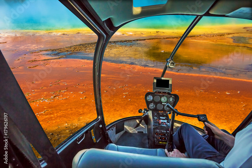 Helicopter cockpit with control console inside the cabin flight over Grand Prismatic Spring in the Midway Geyser Basin, largest thermal feature in Yellowstone NP, Wyoming and Montana, United States.
