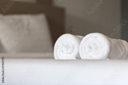 White towel on the bed in hotel room