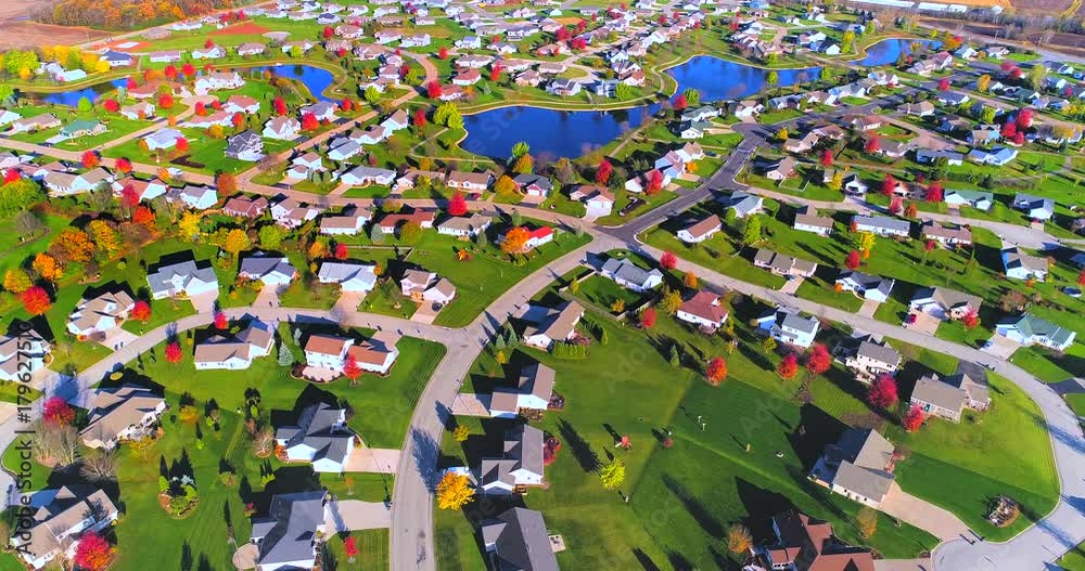 Aerial flyover of Autumn colors, beautiful neighborhood in small town America. 
