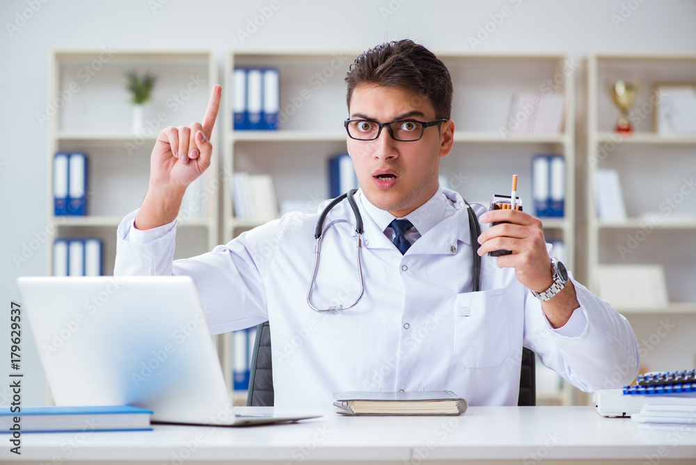 Male doctor in anti-smoking conceptwithcigarette pack Male doctor in anti-smoking conceptwithcigarette pack