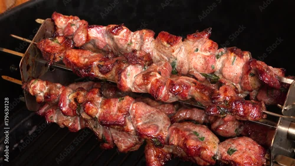 Fragrant shish kebab Shashlik is roasted on skewers on the gas grill Fragrant shish kebab Shashlik is roasted on skewers on the gas grill
