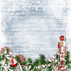 Christmas decor with a nutcracker and candy cane. with firtree on snow background
