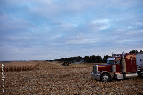 Large semi road transport waiting in a maize field