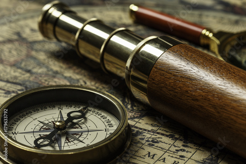 Retro compass with old map and spyglass