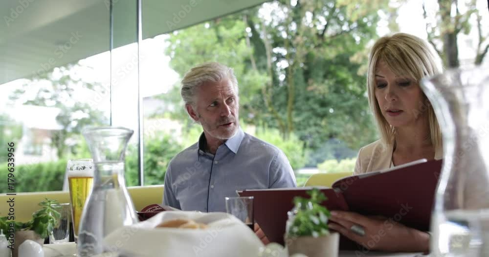 Colleagues reading a menu in a restaurant Colleagues reading a menu in a restaurant