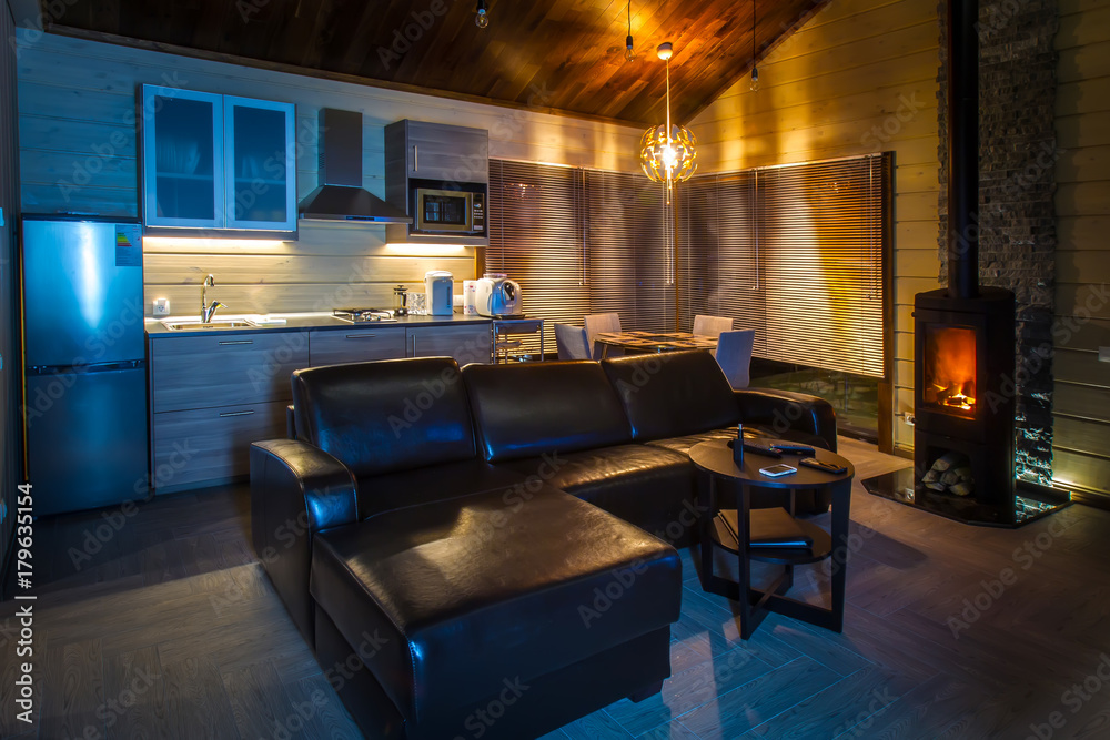 Living room with a burning fireplace. Living room with sofa. Private cottage. Living room with a burning fireplace. Living room with sofa. Private cottage.