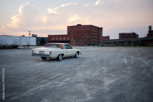 Blurry vintage car drifting in industrial depot