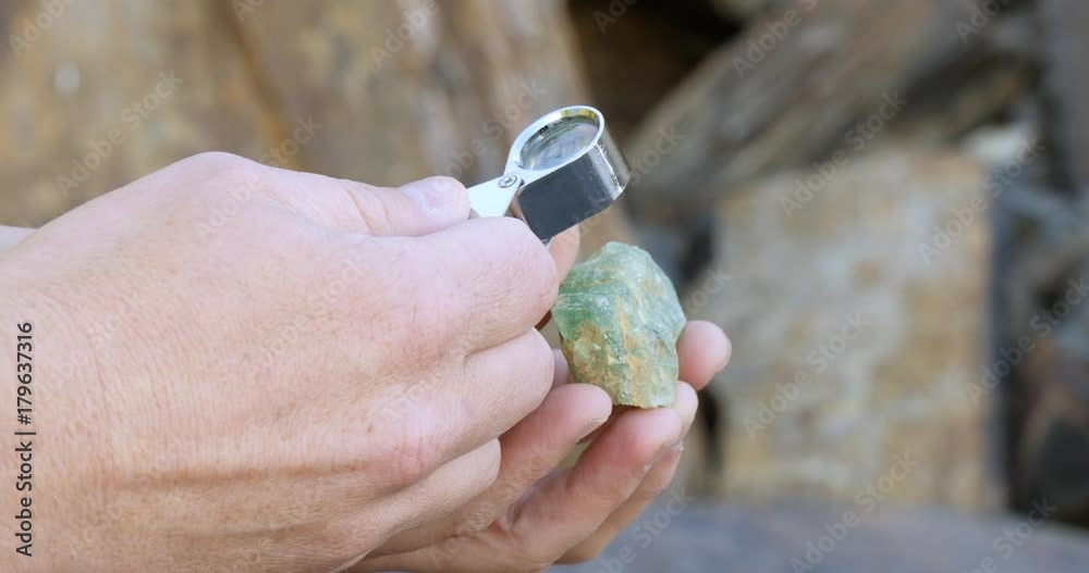 Close up look at mineral fluorite with loope hand lens mining exploration 