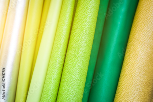 A close-up of colorful leather: green, light green, yellow, beige. Pattern made of genuine leather