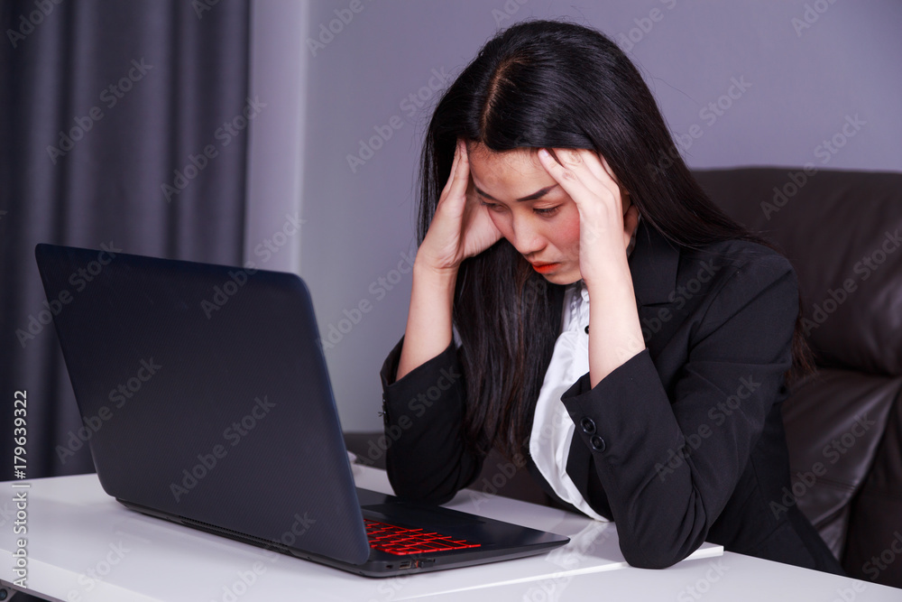 woman in business suit working with laptop in stress desperate woman in business suit working with laptop in stress desperate