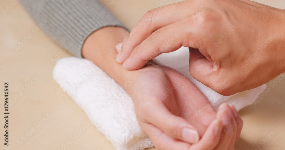 Chinese medical doctor takes the pulse of a patient Chinese medical doctor takes the pulse of a patient