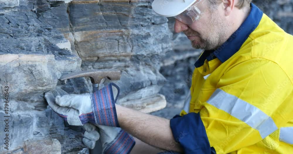 Mining prospect mineral exploration Geologist taking field rock data sample