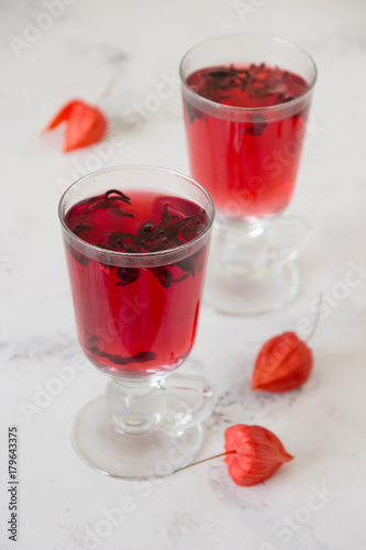 Red hibiscus tea in a glass cups on a table