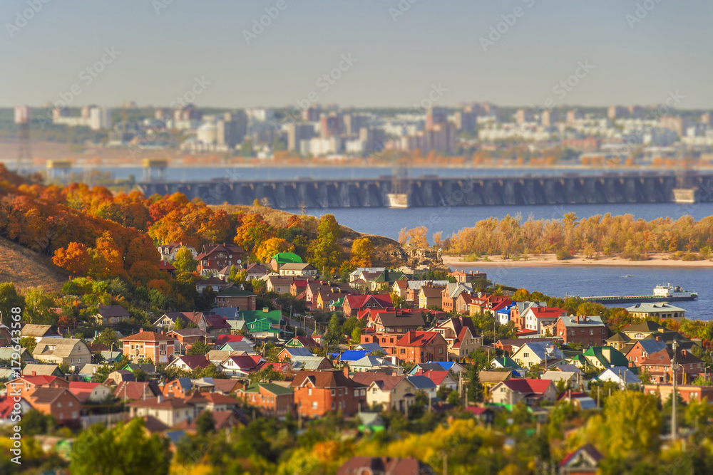 A small settlement on a hillside in the autumn season on a sunny day.