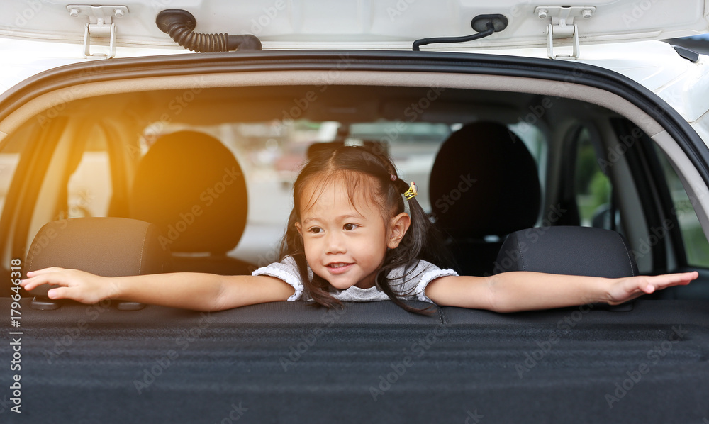 Happy little asian child looking out from the window of the car. Happy little asian child looking out from the window of the car.