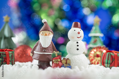 Santa claus and Snowman sitting Together on bokeh background. Christman Concept.